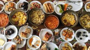 a table topped with lots of different dishes of food at Cleopatra Antique Hotel in Urfa