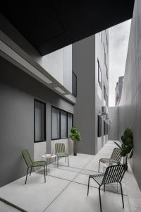 a corridor with chairs and tables in a building at Cove Alexa in Jakarta +15 photos