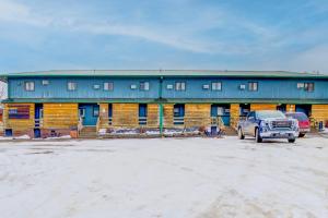 a blue building with a truck parked in front of it at Bel Aire Motel Chamberlain Near Missouri River I 90 in Chamberlain +65 photos