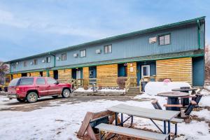 a red truck parked in front of a building at Bel Aire Motel Chamberlain Near Missouri River I 90 in Chamberlain