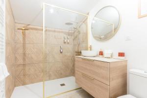 a bathroom with a shower and a sink and a mirror at Serenity Appart', Les Clés de l'Espoir, proche Poitiers in Nieuil-lʼEspoir +38 photos