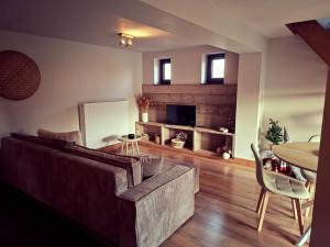a living room with a couch and a table at B&B De Geythoek in Sijsele