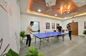 a group of people playing a game of ping pong at EKOSTAY - Blue Door Villa in Alibaug