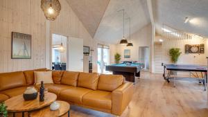 a living room with a couch and a pool table at Villavilla 474 - Grenå Strand, Østjylland in Grenå