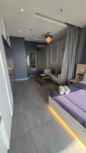 a bedroom with a bed and a living room at Lake Side Drift by Luxury loft 37th floor in Noida