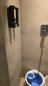 a bathroom with a blue toilet in a stall at Lake Side Drift by Luxury loft 37th floor in Noida +19 photos