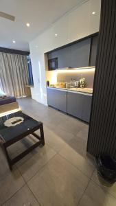 a living room with a table and a kitchen at Lake Side Drift by Luxury loft 37th floor in Noida