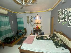 a bedroom with a bed and a ceiling at The Raj palace in Dhaka
