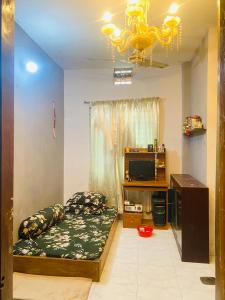 a bedroom with a bed and a television in it at The Raj palace in Dhaka