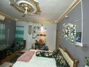 a bedroom with a bed and a ceiling at The Raj palace in Dhaka