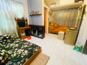 a bedroom with a bed and a television in it at The Raj palace in Dhaka +1 photo