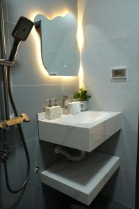 a bathroom with a white sink and a shower at Dubai House in Hanoi +63 photos