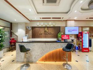 a lobby with a counter and two stools in a store at A25 Hotel - 44 Hàng Bún in Hanoi