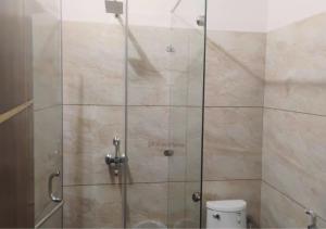 a shower stall in a bathroom with a toilet at Bhimtal Lakeview Cottage in Bhīm Tāl +22 photos