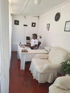 a woman sitting at a desk in a room at Crocodile Rock Lodge in Bulawayo
