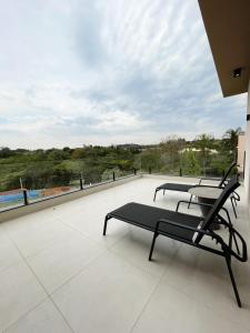 two chairs sitting on the roof of a building at Maison Joia dos Vinhedos in Vinhedo