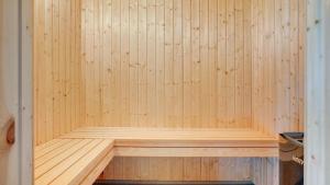 a wooden sauna with a wooden bench in it at Villavilla 530 - Mommark, Sydjylland in Sarup