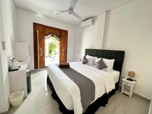 a bedroom with a large bed in a room at Ocean Villa Dive Resort - Tulamben in Tulamben +62 photos