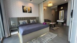 a bedroom with a bed and a living room at Cozy corner by Luxury loft in Noida