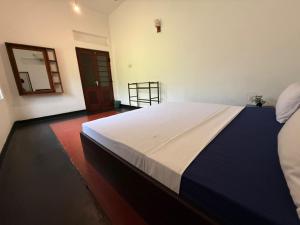 a bedroom with a large bed in a room at Mango Three Resort in Anuradhapura +1 photo
