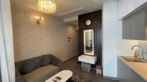 a bathroom with a couch and a sink and a mirror at Cozy corner by Luxury loft in Noida +34 photos