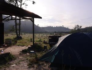 a tent sitting in a field next to a car at Ditrek Adventure in Ðại Lào
