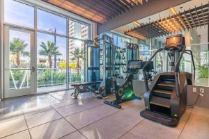 a gym with exercise equipment and a large window at @ Marbella Lane - Luxury Beachside 2BR in Long Beach