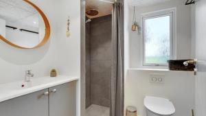 a bathroom with a toilet and a sink and a shower at Villavilla 546 - Hostrup Strand, Limfjorden in Spottrup +40 photos