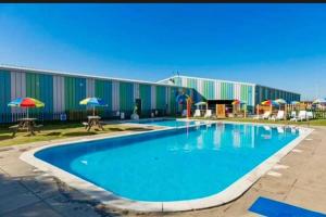 a large swimming pool in front of a building at Seaside Lodge Haven in St Osyth in Jaywick Sands