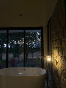 a bath tub in a room with a window at Gulab Bagh Jawai in Jawāi Bāndh +18 photos