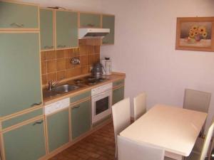 a small kitchen with a sink and a stove at Haus 55 Fewo EG in Arrach
