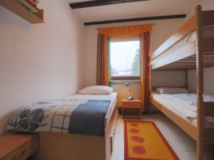 a bedroom with two bunk beds and a window at Haus 55 Fewo EG in Arrach