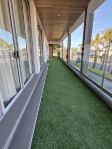 an empty hallway with green grass in a building at Harbour Retreat in Hayborough