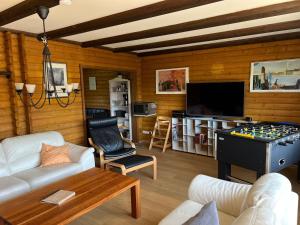 a living room with a couch and a table with a foos ball at Haus 68 Bergblick in Arrach