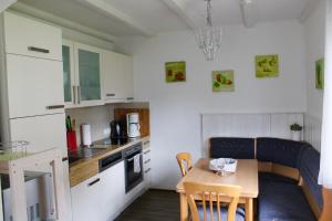a small kitchen with a small table and a small dining room at Haus 68 Bergblick in Arrach