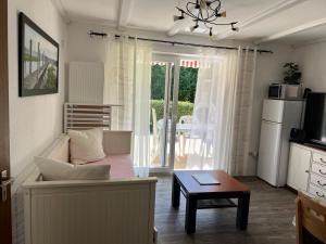 a living room with a couch and a table at Haus 23 Seeblick in Arrach +31 photos