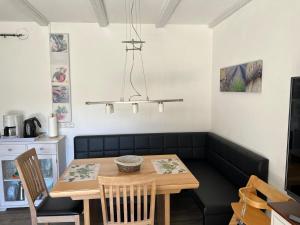 a dining room with a table and chairs at Haus 23 Seeblick in Arrach