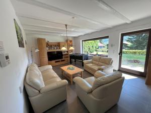 a living room with two couches and a table at Haus 44 Feldblick in Arrach