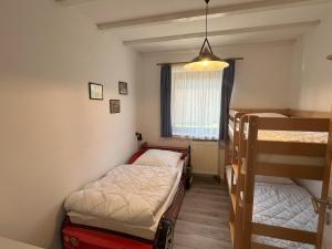 a room with two bunk beds and a window at Haus 44 Feldblick in Arrach