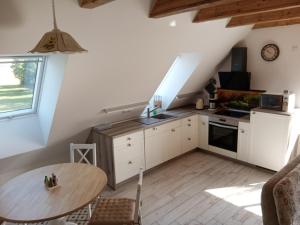 a kitchen with a table and a kitchen with a stove at Fewo Zur Windmühle in Pegau