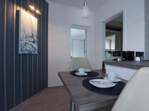 a dining room with a table with two plates on it at Kirchenplatz 6 Apartment 17 in Warnemünde +3 photos