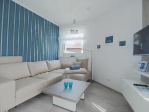 a living room with a white couch and a coffee table at Kirchenplatz 6 Apartment 17 in Warnemünde