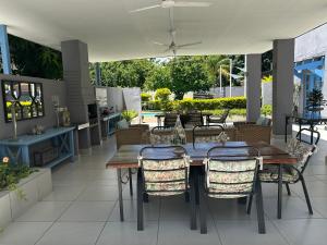 a patio with a wooden table and chairs at Aflica Apartments in Gaborone