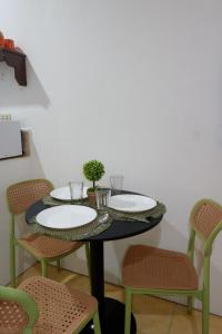 a dining room table with plates and chairs at Villa Solaj Dumaguete in Aganan
