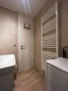 a bathroom with a toilet and a sink and a door at Velvet Alps Bovec in Bovec