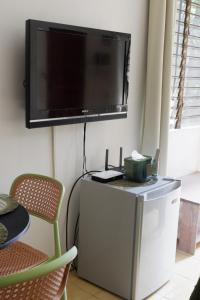 a flat screen tv hanging on a wall at Villa Solaj Dumaguete in Aganan