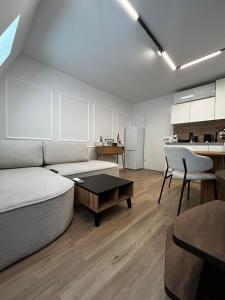 a living room with a couch and a table at Velvet Alps Bovec in Bovec