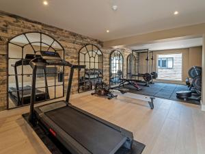 a gym with a treadmill and several treadmills at Bell House in Amlwch
