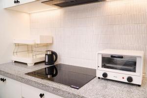 a kitchen with a toaster oven on a counter at KNV Apartment in Thu Dau Mot