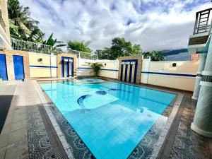 a swimming pool in the middle of a building at La Roma - Hot Spring Private Resort in Pansol +28 photos